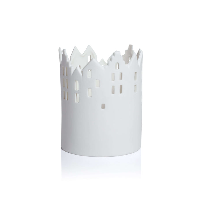 White decorative candle holder with cut-out design on a white background