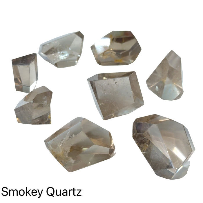Mini Smokey Quartz freeform polished pocket stone for grounding and anxiety relief on a white background, front overview.