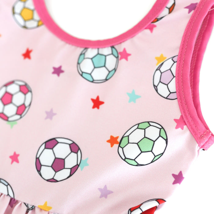 closeup of colorful soccer ball and petite star print on pastel pink dress bodice with bright pink trim