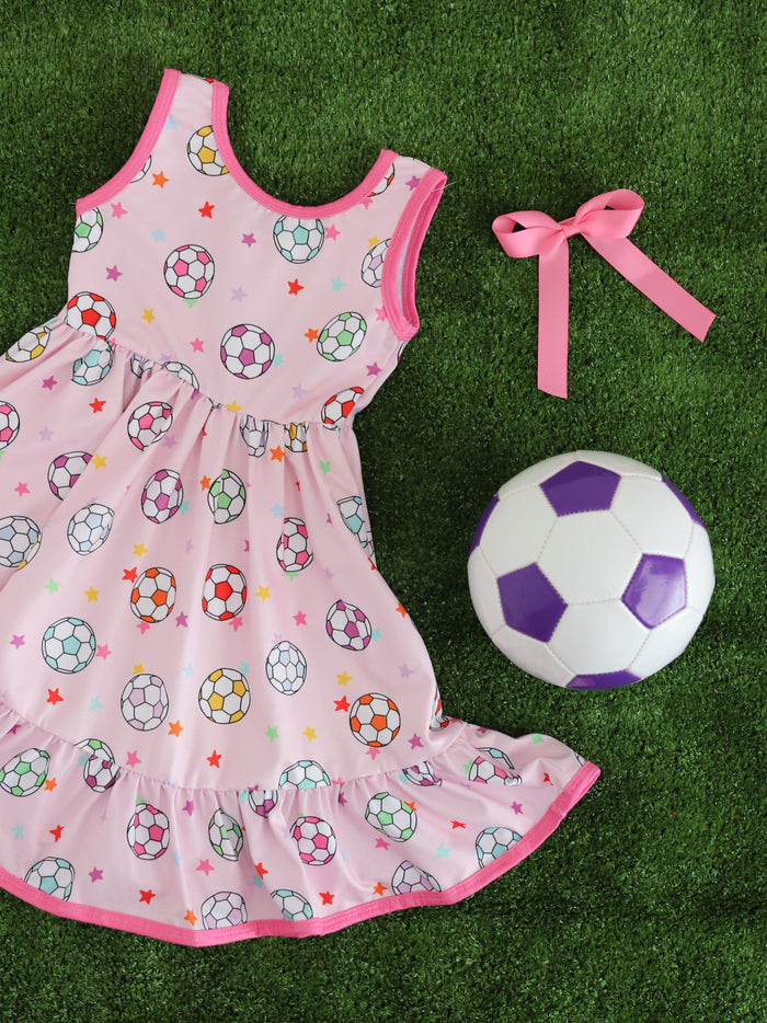 girls' pink sleeveless soccer ball print twirl dress styled with matching bright pink satin hair bow and soccer ball