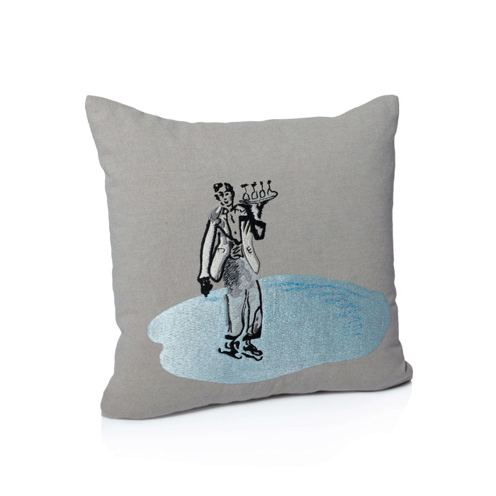 Gray pillow with a decorative design of a person holding a globe on a white background