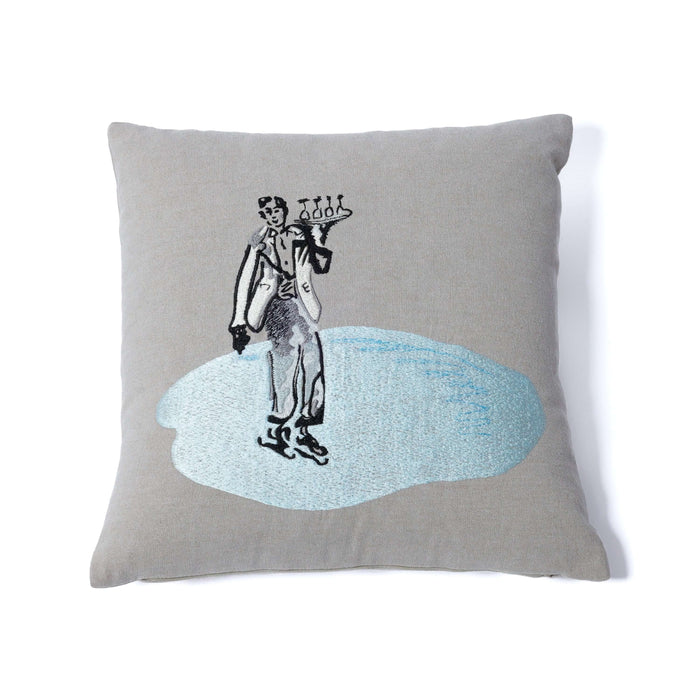 Gray pillow with a black and white illustration of a person on a skateboard on a blue splash background