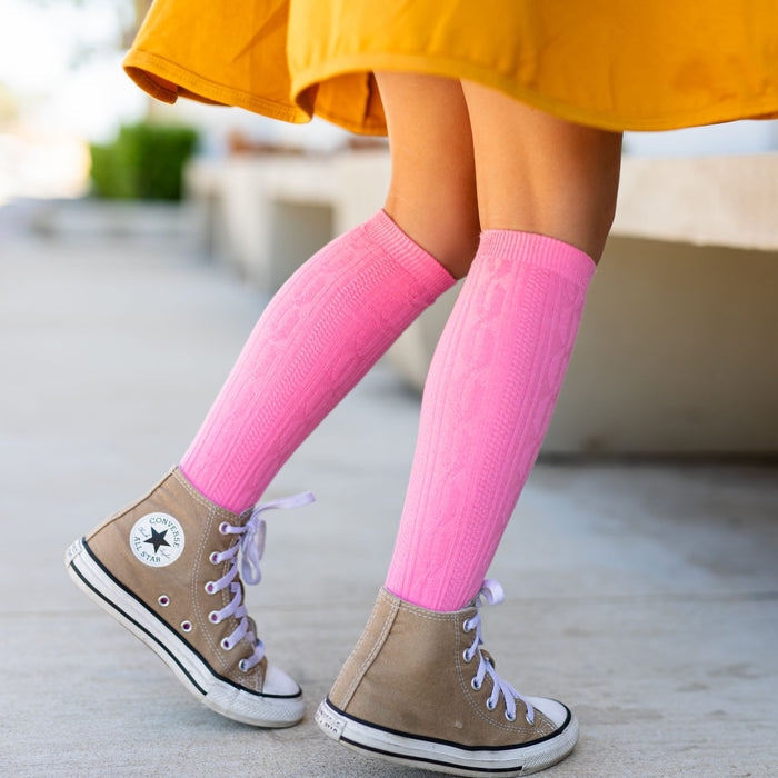 girls cable knit knee high socks in pink paired with high tops and mustard yellow twirl dress