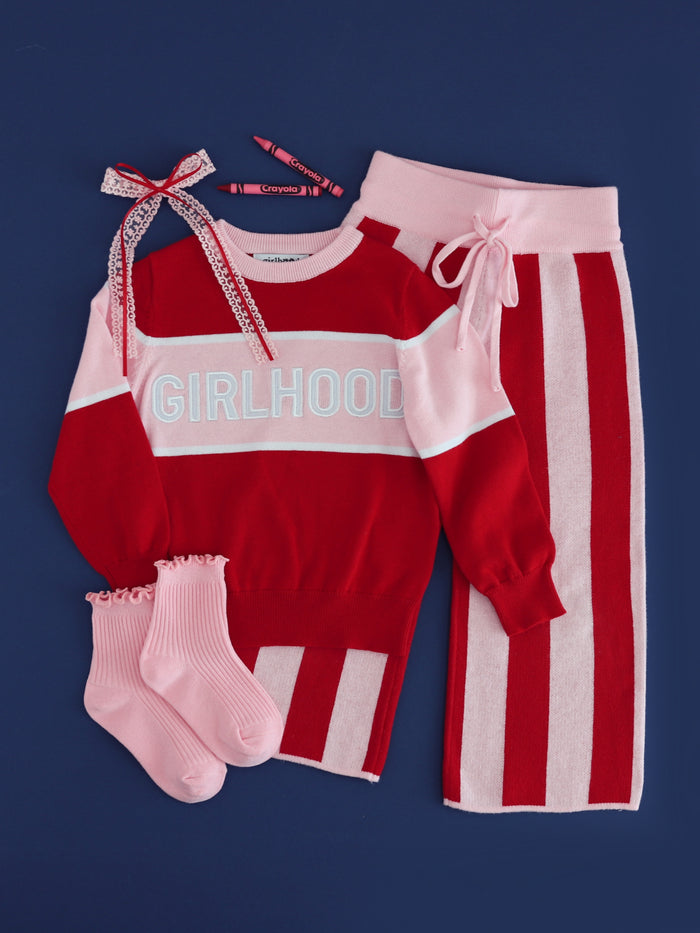 girls red and pink cotton knit sweater set with "girlhood" embroidered pullover, matching red and pink striped sweater pants and accessories for back to school